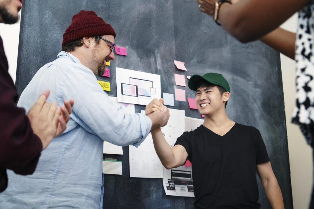 People collaborating around a board with notes and diagrams.